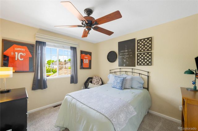 a bathroom with a sink a toilet and shower curtain
