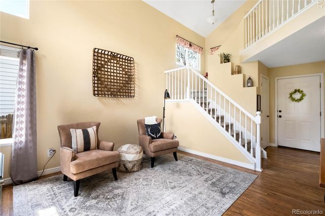 a living room with furniture and stairs
