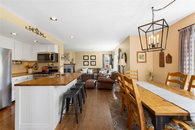 a large kitchen with stainless steel appliances lots of counter space dining table and chairs