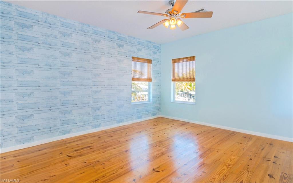 12277 Boat Shell Drive Matlacha Isles, FL 33991 - Photo 13 of 46 a view of empty room with wooden floor and fan
