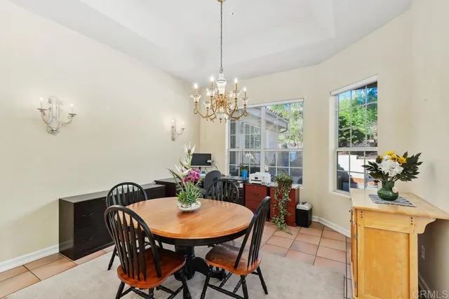 a view of a dining room with furniture and a chandelier