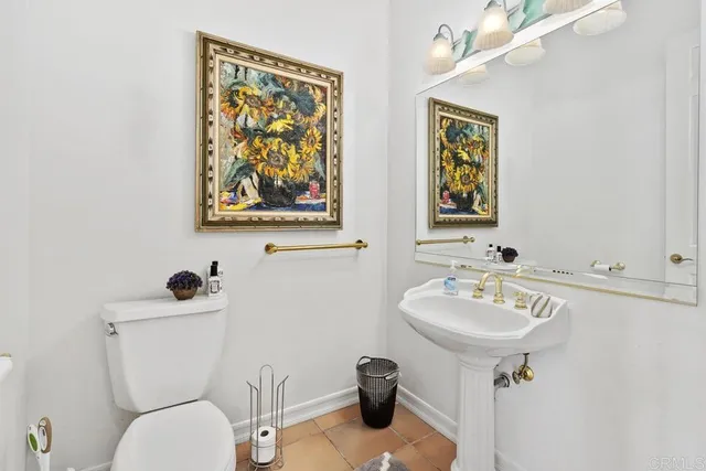 a bathroom with a toilet a sink and mirror