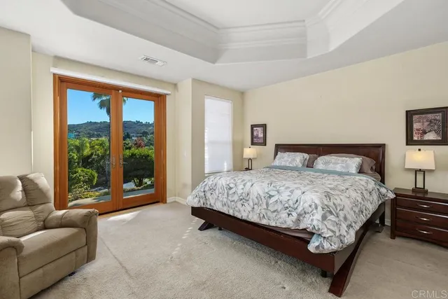 a bedroom with a bed and glass window