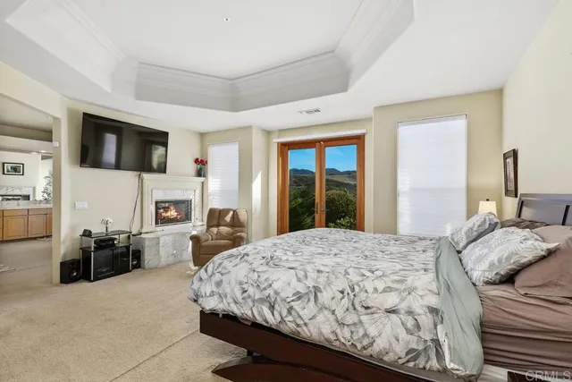 a bedroom with a large bed and a flat screen tv