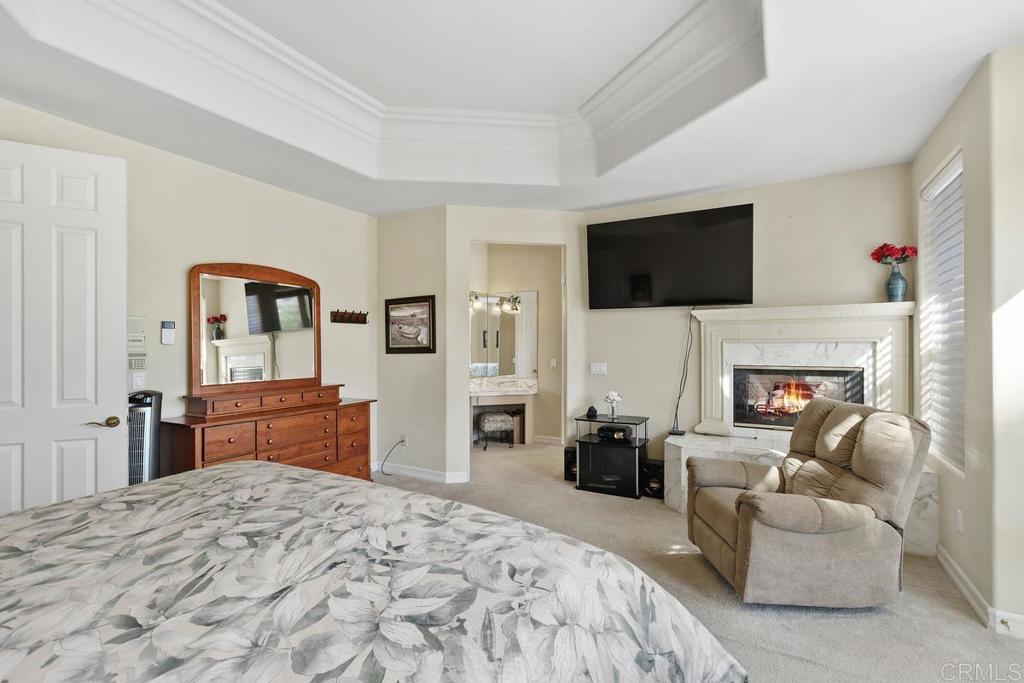 3068 Southwind Lane Vista, CA 92084 - Photo 19 of 44 a bedroom with a bed a flat screen tv and dresser