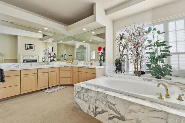 a spacious bathroom with a sink mirror and a bath tub