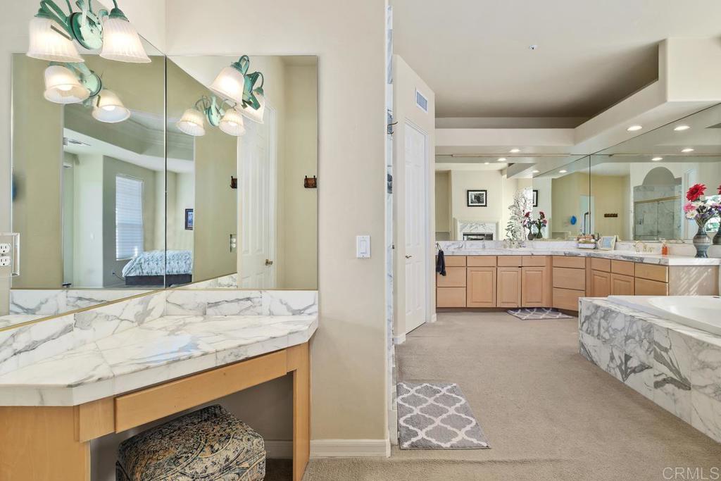 3068 Southwind Lane Vista, CA 92084 - Photo 22 of 44 a bathroom with a granite countertop sink and a mirror