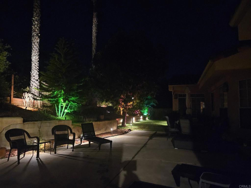 3068 Southwind Lane Vista, CA 92084 - Photo 35 of 44 a view of a patio with table and chairs with plants and trees