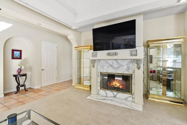 a living room with a fireplace and a flat screen tv