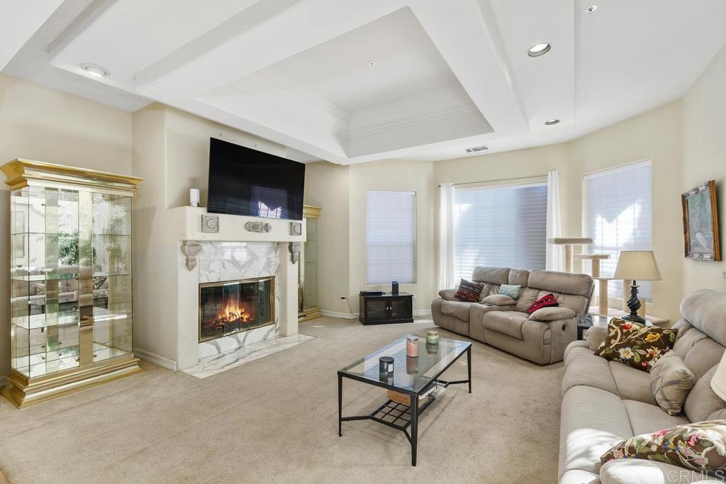 3068 Southwind Lane Vista, CA 92084 - Photo 6 of 44 a living room with furniture a flat screen tv and a fireplace