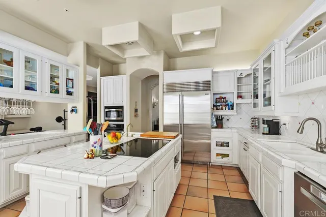 a kitchen with stainless steel appliances kitchen island granite countertop a sink and cabinets