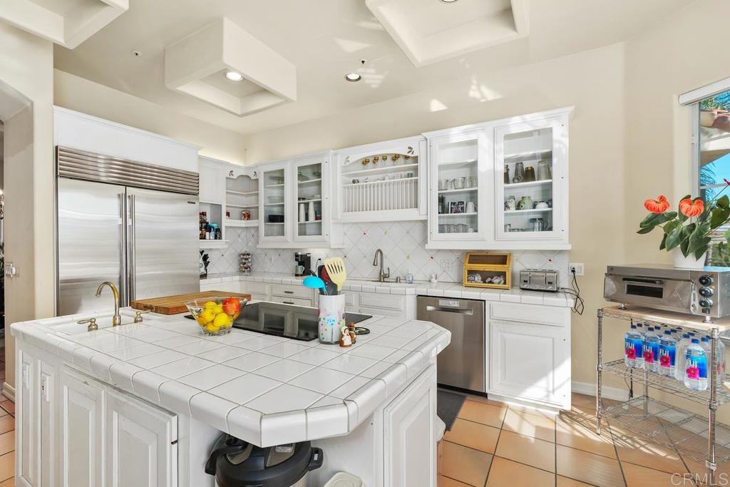 3068 Southwind Lane Vista, CA 92084 - Photo 9 of 44 a kitchen with a sink a stove and chairs