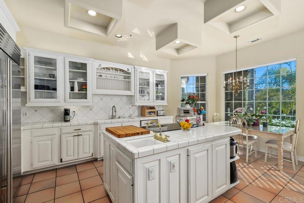 3068 Southwind Lane Vista, CA 92084 - Photo 10 of 44 a kitchen that has a sink and chairs in it