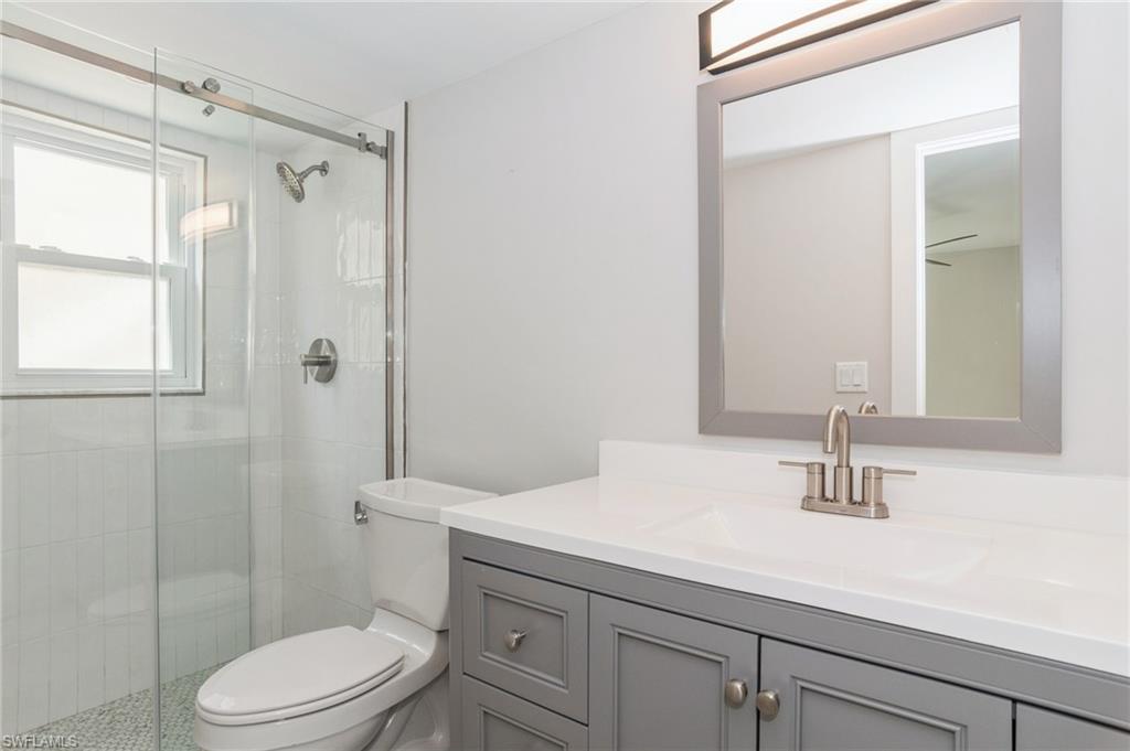 1155 Sandpiper Street, Unit B3 Naples, FL 34102 - Photo 11 of 21 Full bathroom featuring a stall shower and vanity