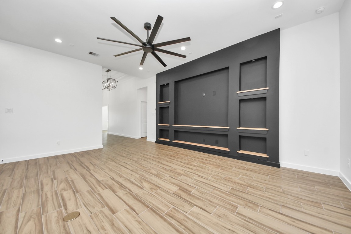 207 Manor Avenue Arcola, TX 77583 - Photo 12 of 37 a view of a livingroom with wooden floor and a ceiling fan