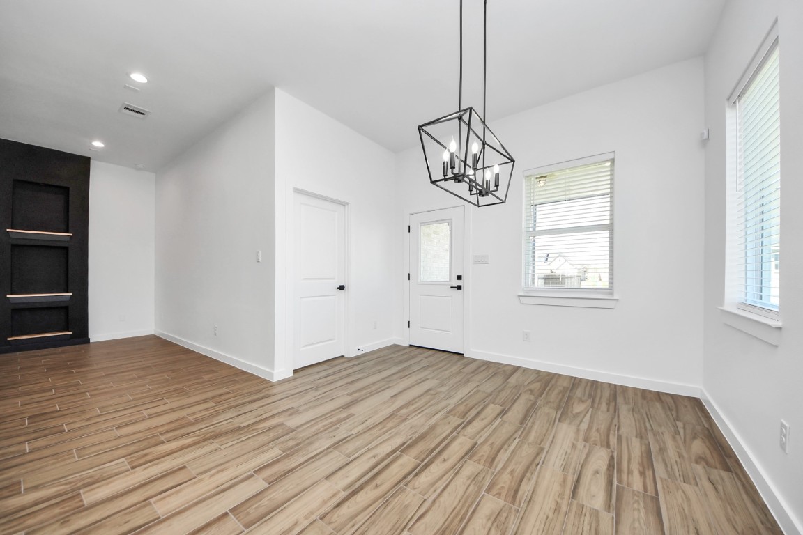 207 Manor Avenue Arcola, TX 77583 - Photo 16 of 37 a view of empty room with wooden floor and window