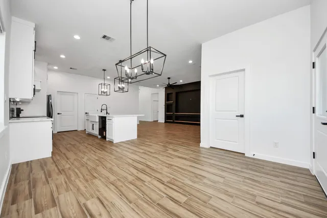 a view of a kitchen with furniture and wooden floor