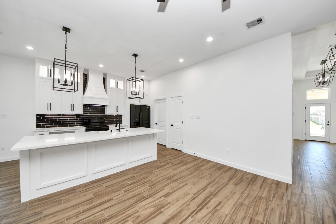 207 Manor Avenue Arcola, TX 77583 - Photo 19 of 37 a large kitchen with a large counter top appliances and cabinets