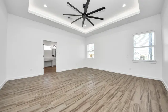 wooden floor in an empty room with a window
