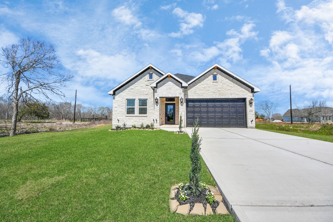 207 Manor Avenue Arcola, TX 77583 - Photo 37 of 37 a front view of a house with a garden and yard