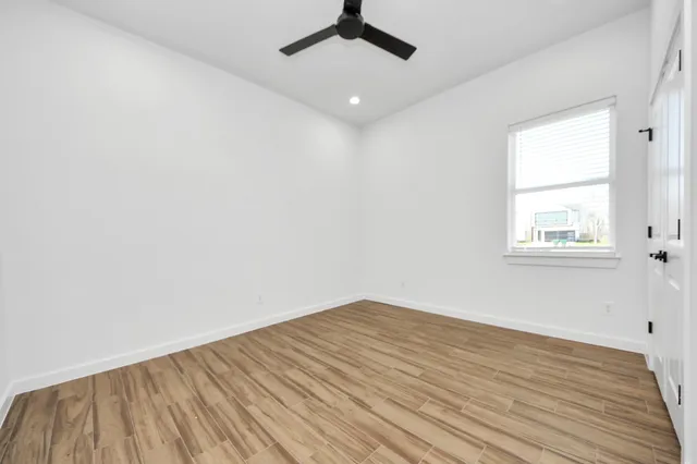 wooden floor in an empty room with a window