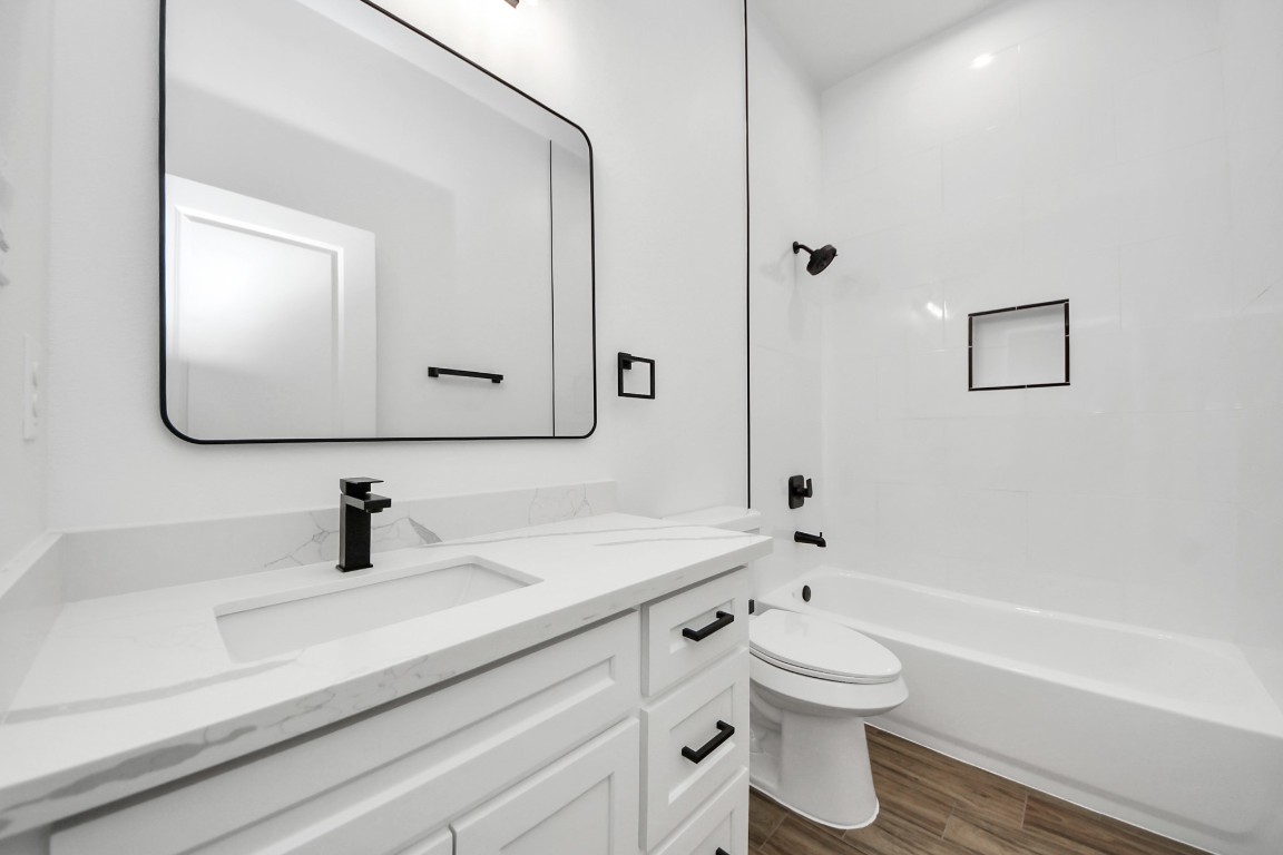 207 Manor Avenue Arcola, TX 77583 - Photo 7 of 37 a bathroom with a toilet a sink and a mirror
