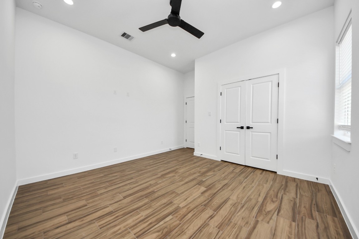 207 Manor Avenue Arcola, TX 77583 - Photo 9 of 37 a view of an empty room with wooden floor and a window