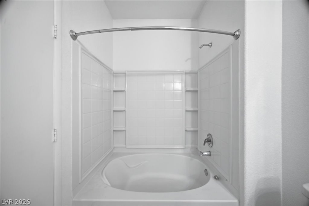 9050 West Warm Springs Road, Unit 1033 Las Vegas, NV 89148 - Photo 14 of 26 Relax and unwind in this deep soaking tub with convenient shower surround shelving.