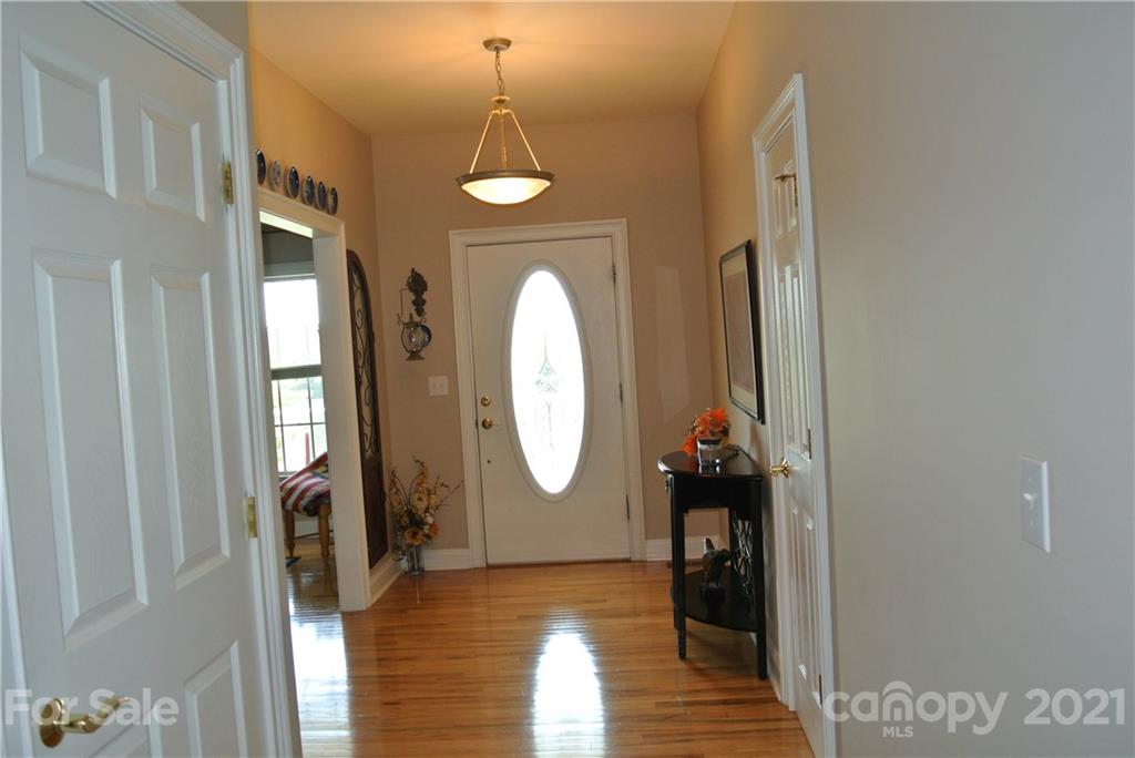 1911 Coxe Road Rutherfordton, NC 28139 - Photo 11 of 37 a view of a livingroom with wooden floor and a chandelier