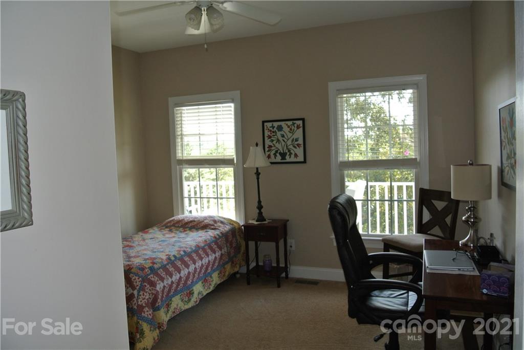1911 Coxe Road Rutherfordton, NC 28139 - Photo 30 of 37 a bedroom with a bed windows and chair