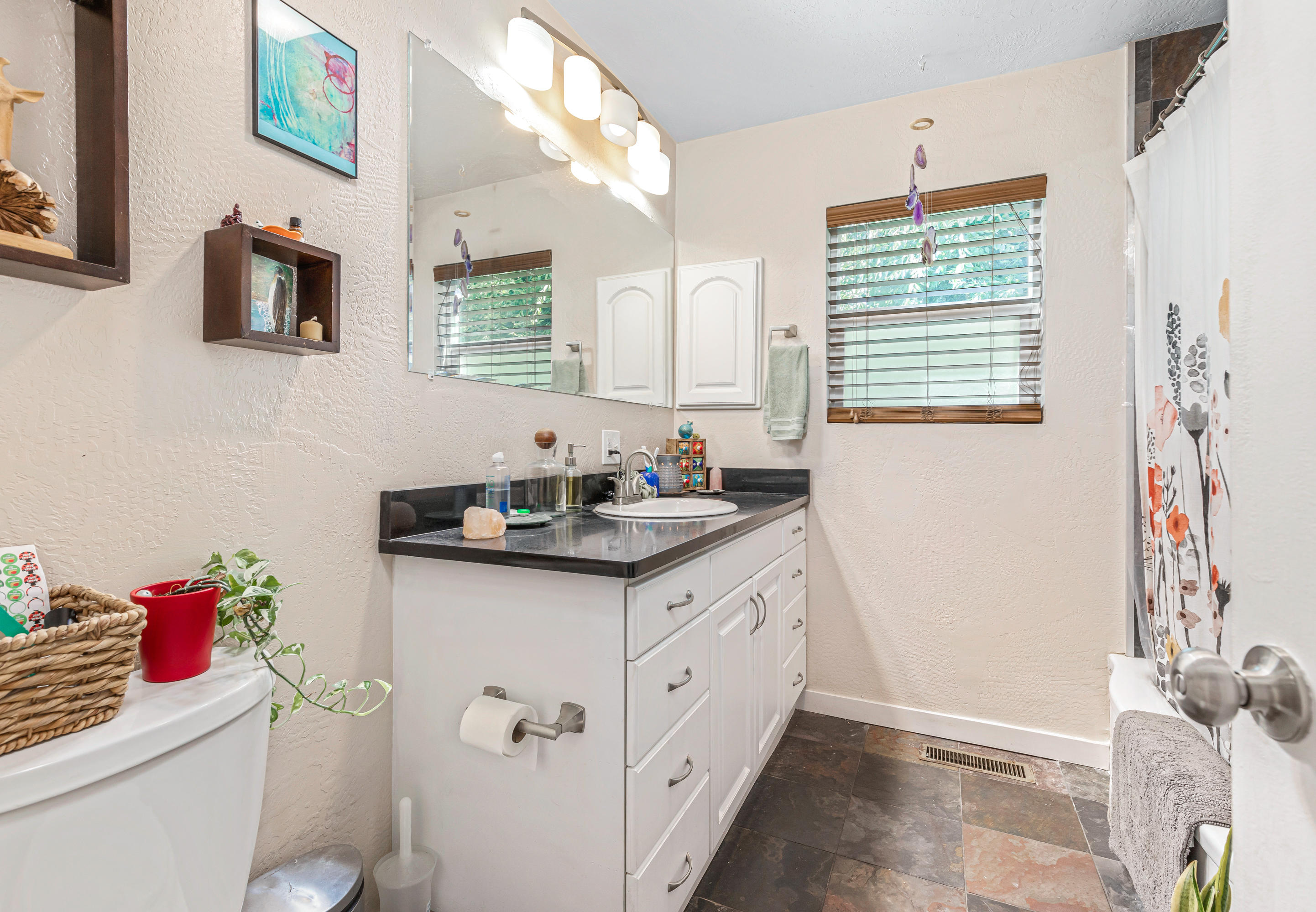 2425 Table Rock Road Medford, OR 97501 - Photo 12 of 26 a bathroom with a granite countertop sink a toilet and a shower curtain