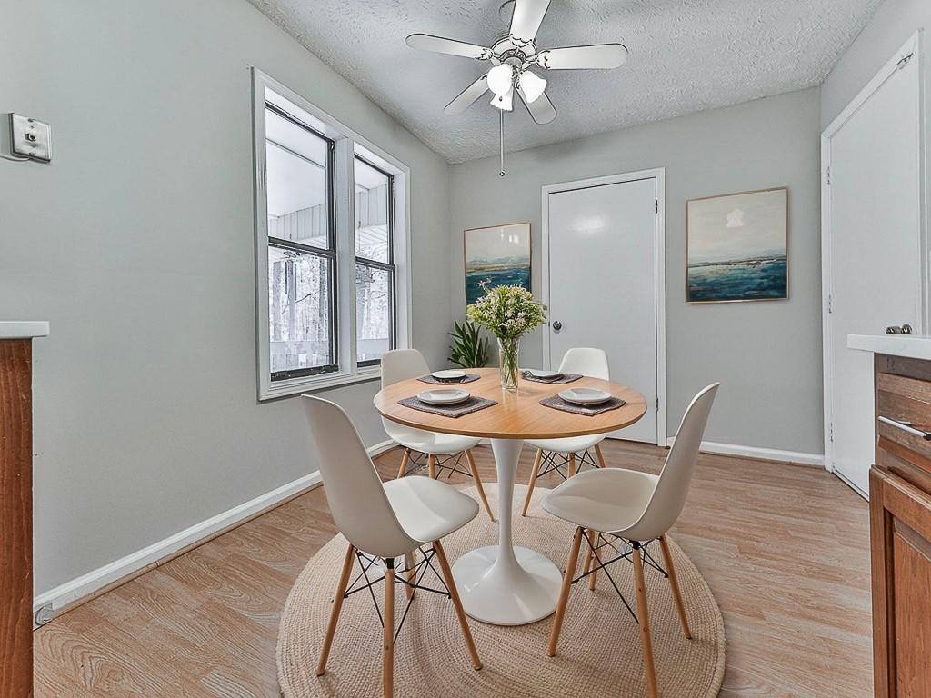 5506 Vaughn Road Woodstock, GA 30188 - Photo 11 of 33 a view of a dining room with furniture window and wooden floor