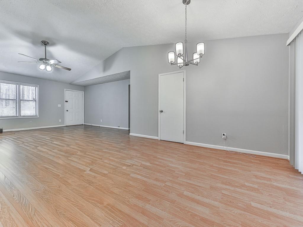 5506 Vaughn Road Woodstock, GA 30188 - Photo 14 of 33 a view of an empty room with window and wooden floor