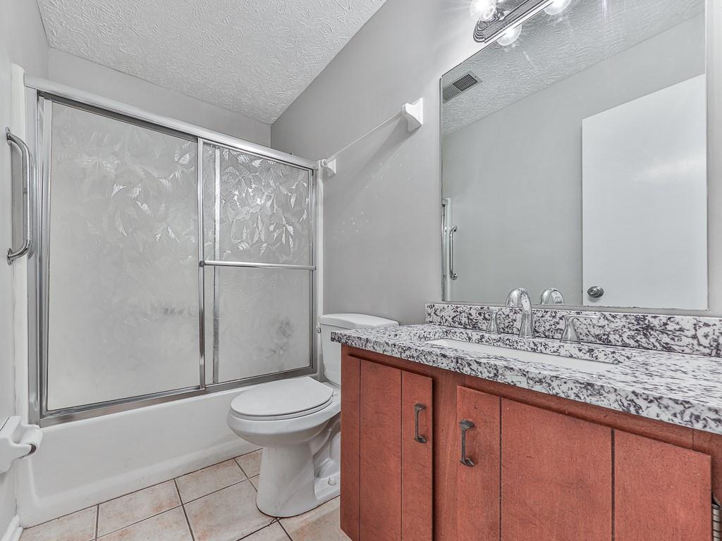 5506 Vaughn Road Woodstock, GA 30188 - Photo 15 of 33 a bathroom with a granite countertop sink toilet and shower