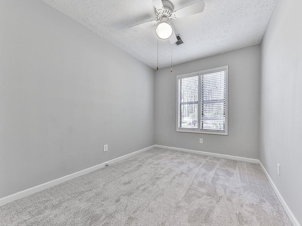 5506 Vaughn Road Woodstock, GA 30188 - Photo 16 of 33 wooden floor in an empty room with a window
