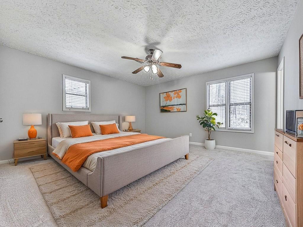 5506 Vaughn Road Woodstock, GA 30188 - Photo 18 of 33 a bed room with a bed and a chandelier