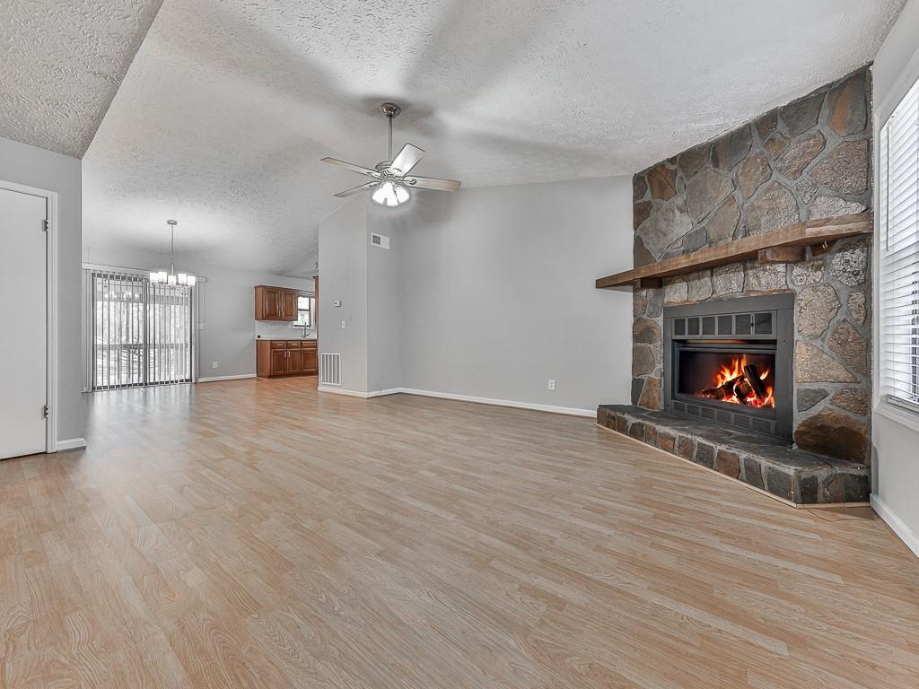 5506 Vaughn Road Woodstock, GA 30188 - Photo 2 of 33 a view of an empty room with wooden floor fireplace and a window