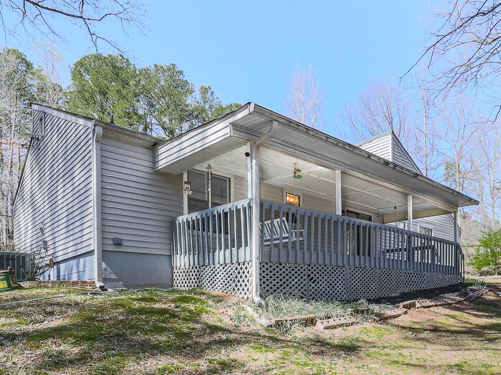 5506 Vaughn Road Woodstock, GA 30188 - Photo 26 of 33 a view of a house with a small yard and wooden fence