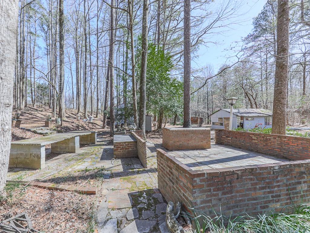 5506 Vaughn Road Woodstock, GA 30188 - Photo 27 of 33 a view of a house with backyard and sitting area