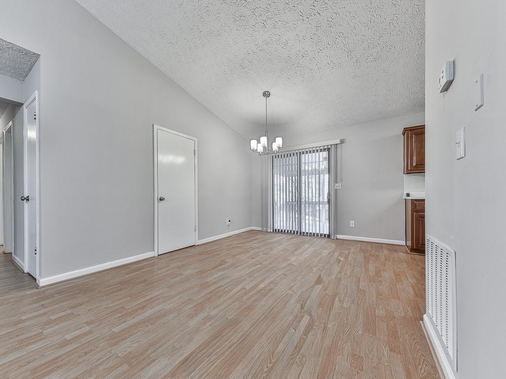 5506 Vaughn Road Woodstock, GA 30188 - Photo 6 of 33 a view of an empty room with wooden floor and a window