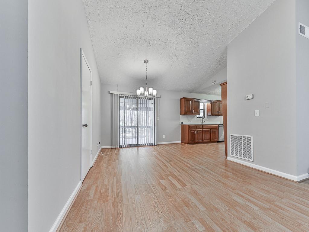 5506 Vaughn Road Woodstock, GA 30188 - Photo 7 of 33 wooden floor in an empty room with a window