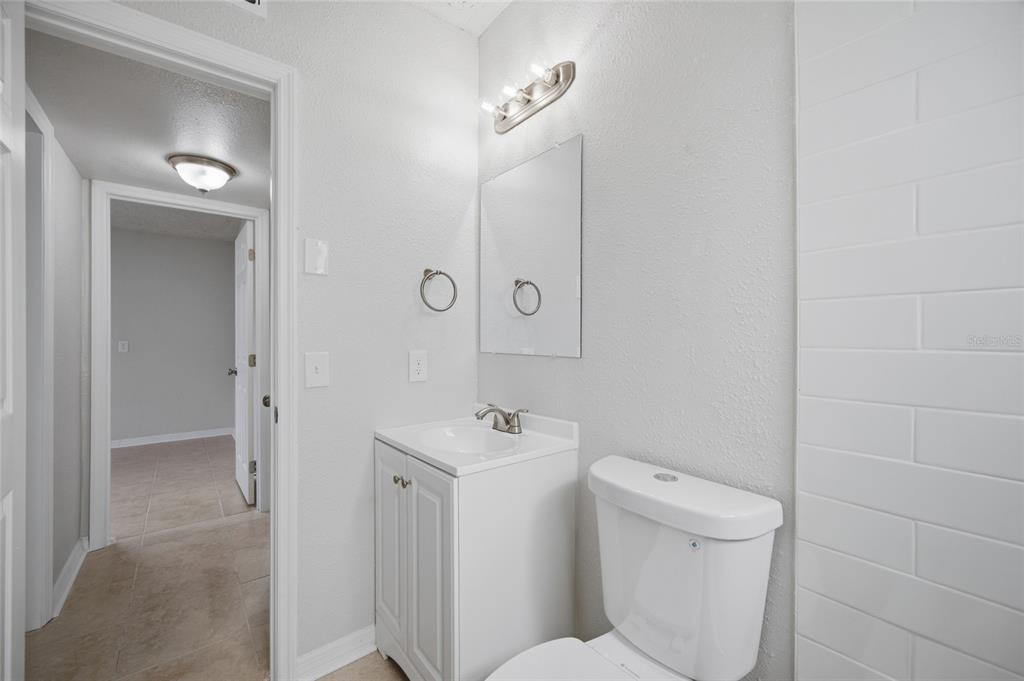 6629 Sierra Terrace New Port Richey, FL 34652 - Photo 15 of 30 a bathroom with a toilet sink and mirror