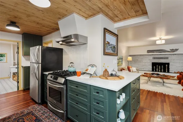 a kitchen with stainless steel appliances a stove refrigerator and a sink
