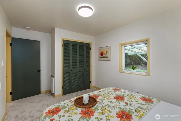 a bedroom with a bed and a window