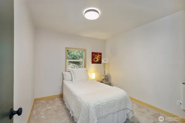 a bedroom with a bed and hallway