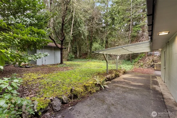 a view of a house with backyard and sitting area