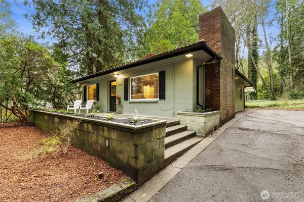a view of house with swimming pool outdoor seating