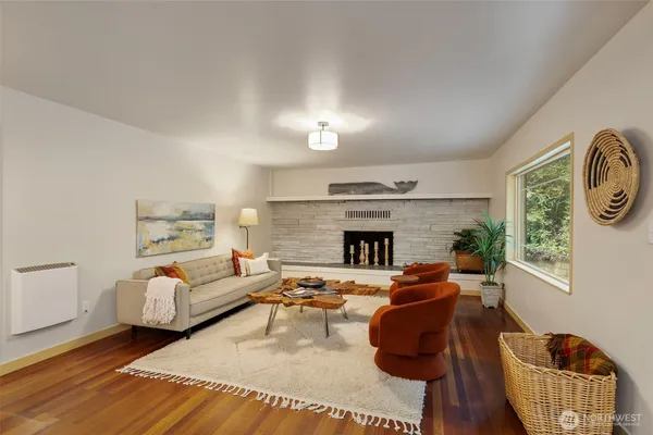 a living room with furniture a fireplace and a window