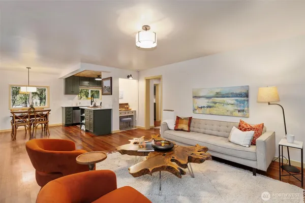 a living room with furniture kitchen view and a table