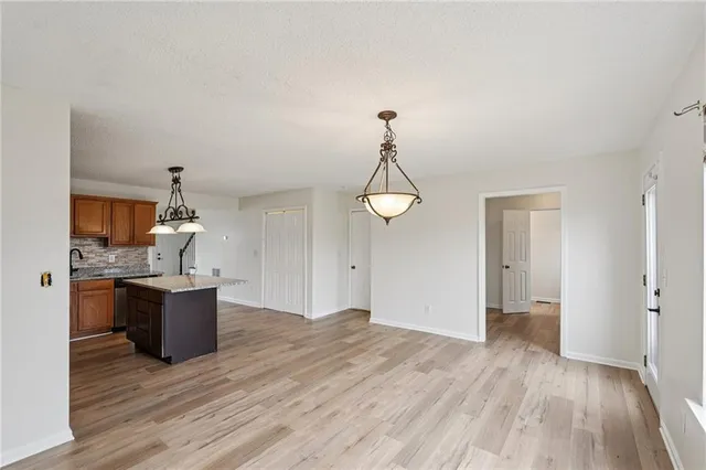 a kitchen with a wooden floor and a stove top oven